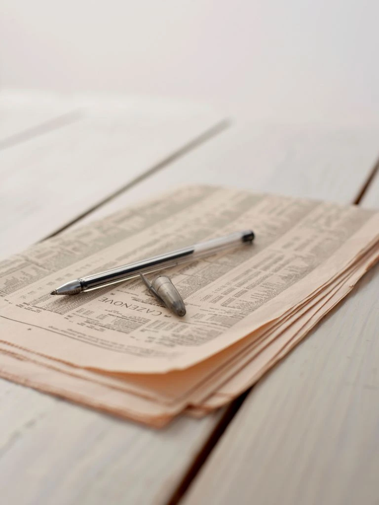 A printed intelligence brief on a desk beside morning coffee